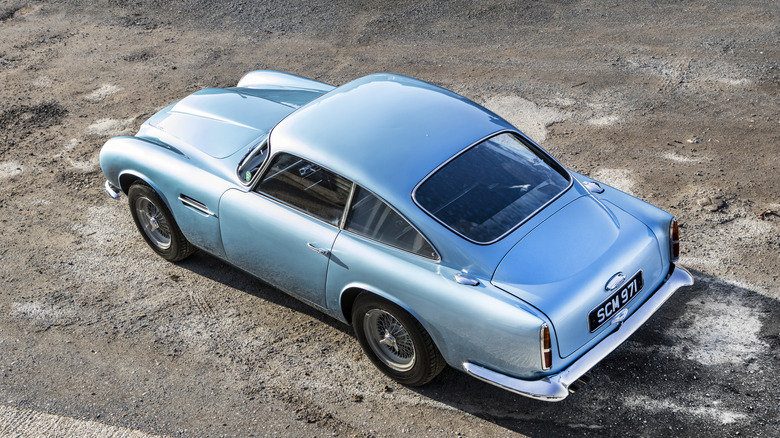 An overhead shot of a light blue 1960s Aston Martin DB4 GT