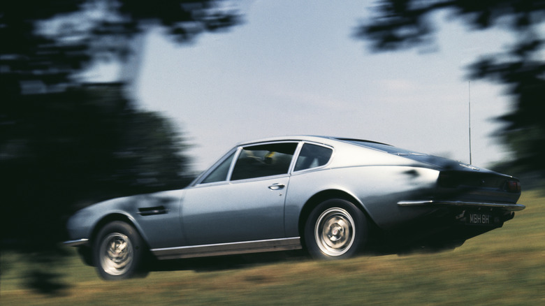A dynamic side shot of a 1970 Aston Martin DBS