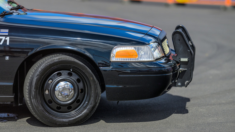 Side shot of a Crown Victoria police car's front end and wheel