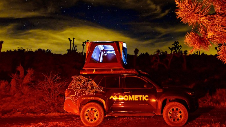 A Dometic rooftop tent on top of a 2026 Toyota 4Runner Trailhunter, shot at night.