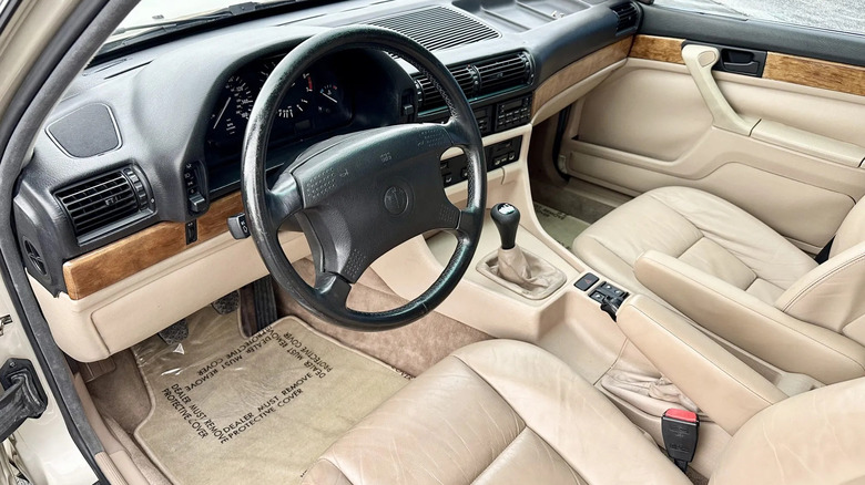 The lightly worn sandy tan leather interior of a 1988 BMW 735i.