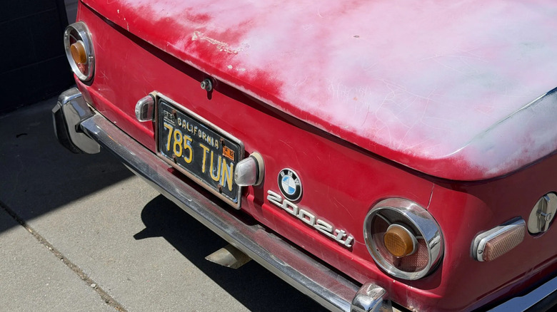 The rear shot of a 1971 BMW 2002ti featuring circular tail lights.