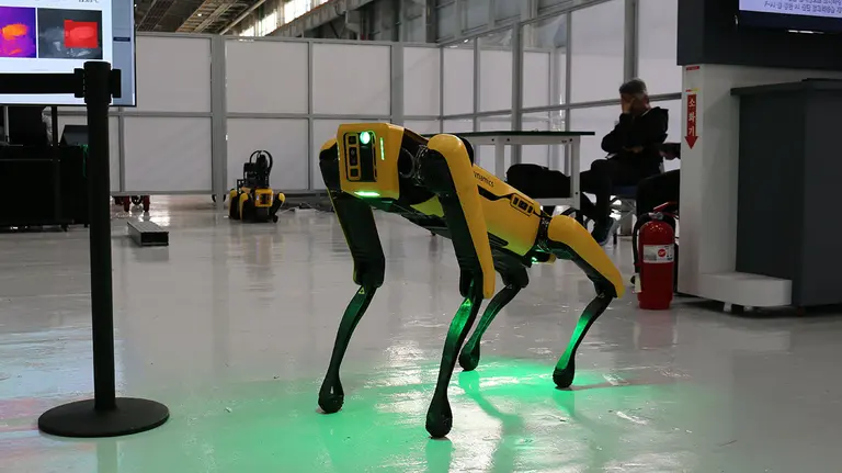 Boston Dynamics' quadruped robot 'SPOT' autonomously patrolling a factory, using various sensors to monitor equipment status in real time