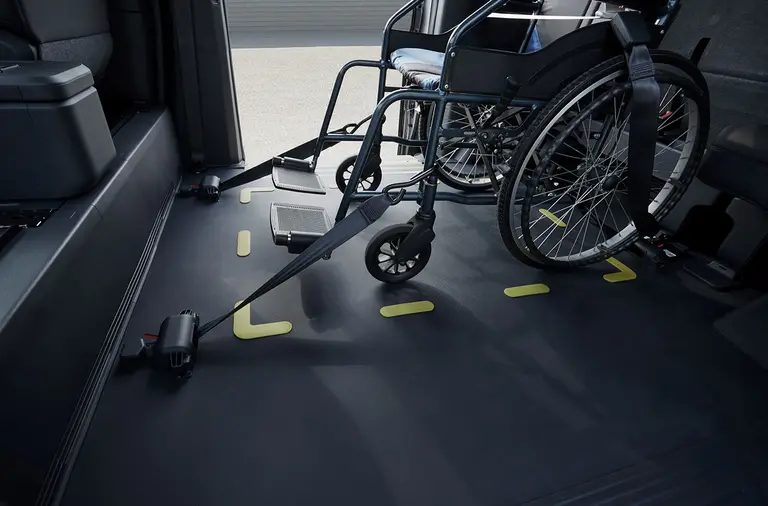 A wheelchair secured inside the Kia PV5 WAV vehicle
