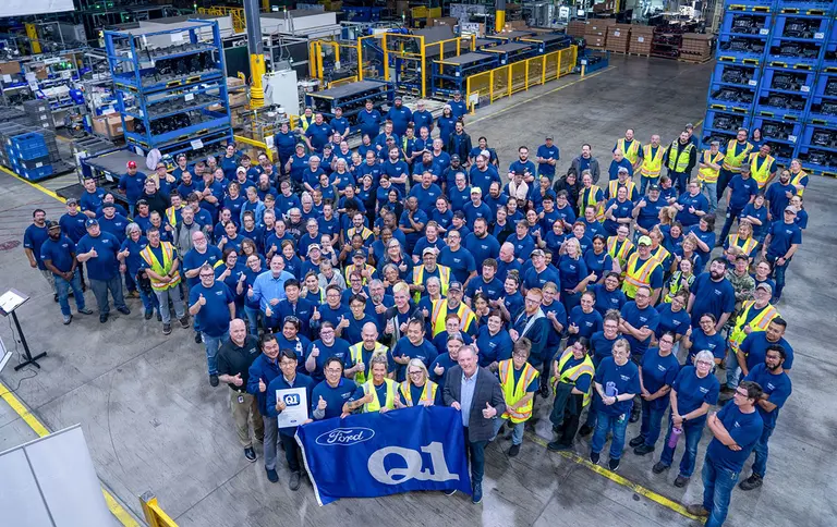 Employees of Hanon Systems' Carey plant holding the Ford Q1 flag