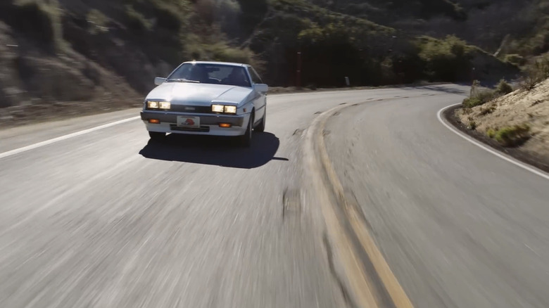 A white '91 Isuzu Impulse RS driving down the road