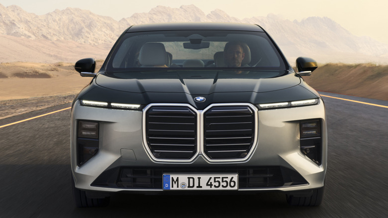 A front-end shot of a facelifted BMW 7-Series with a desert road in the background.