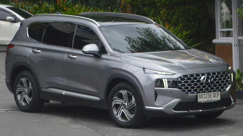 A 2020 gray Hyundai Santa Fe SUV parked in front of a residential building.