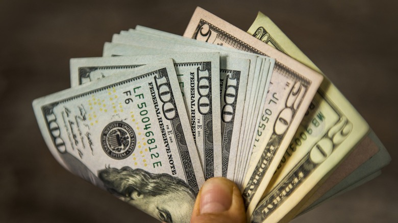 A hand holding cash