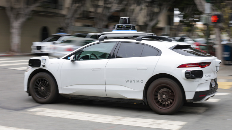 Side view of a Waymo robotaxi self-driving through a San Francisco intersection