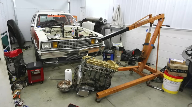 An Atlas 5-culinder engine being put inside a Ford Fairmont drag car