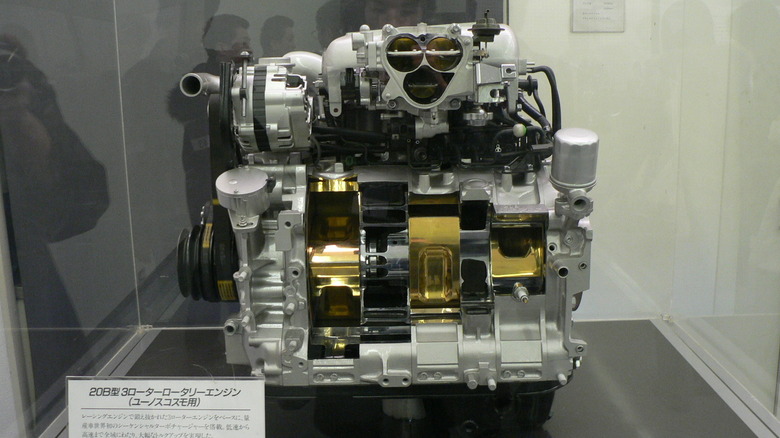 Still image of a Mazda 20B-REW three-rotor engine in museum.
