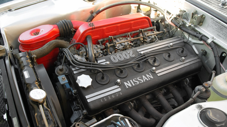 Close-up of a Nissan S20 straight-six under the hood of an early GT-R.