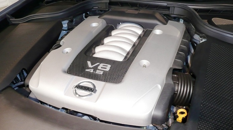 The engine cover of a Nissan 4.5-liter V8 engine is displayed in an engine bay.