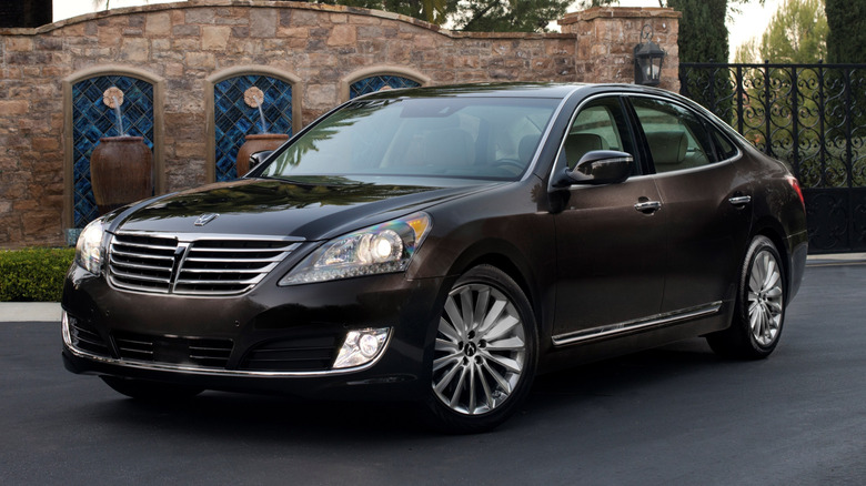 A black 2016 Hyundai Equus parked on a paved driveway in front of an estate
