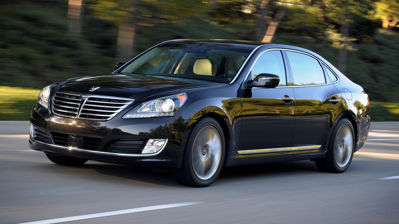 Front 3/4 view of a black 2016 Hyundai Equus driving on a paved road