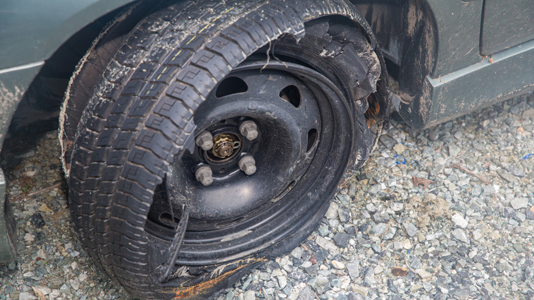 A tire blown off the rim of car.