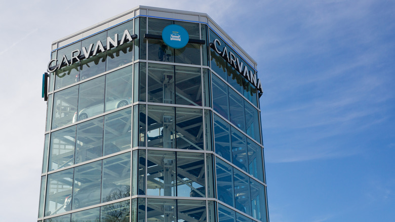 A Carvana tower appears in front of blue skies.